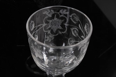 Lot 277 - Two Georgian wine glasses with floral and swag cut bowls on faceted stems on splayed foot 13.5-14 cm (2)