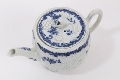 Lot 23 - A Worcester barrel-shaped teapot, circa 1775, relief-moulded and painted with floral patterns, ex-Zoresnky collection, 9.5cm high