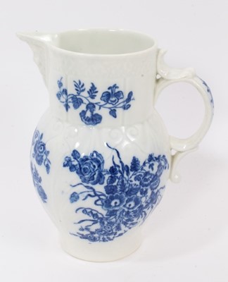 Lot 25 - A Caughley blue and white cabbage leaf moulded jug with mask spout, decorated with bouquets of flowers, S mark to base, 14.5cm high