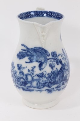 Lot 28 - Worcester blue and white jug, circa 1780, printed in blue with the Parrot Pecking Fruit pattern, mask spout, crescent mark to base, 15cm high