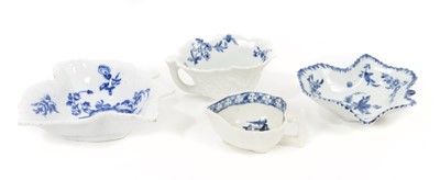Lot 63 - A Derby blue and white leaf-shaped butter boat, circa 1770, painted with an Oriental island, together with a Worcester moulded butter boat decorated with flowers, and two Worcester leaf-moulded pic...