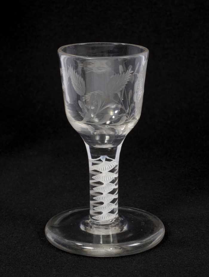 Lot 71 - Georgian double series opaque twist firing glass, circa 1765, the ogee bowl etched with flowers and a bird, on a thick conical foot, 10.75cm high