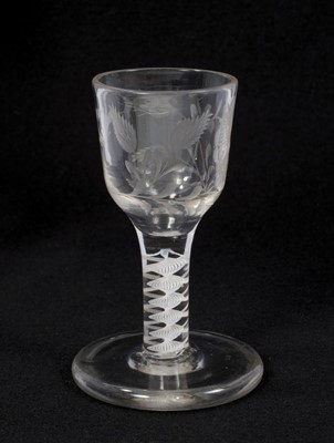 Lot 71 - Georgian double series opaque twist firing glass, circa 1765, the ogee bowl etched with flowers and a bird, on a thick conical foot, 10.75cm high