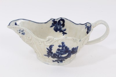 Lot 77 - A Liverpool Pennington blue and white sauceboat, circa 1790, printed with floral sprays, exhibited at Philllips in 1997, 20cm from spout to handle