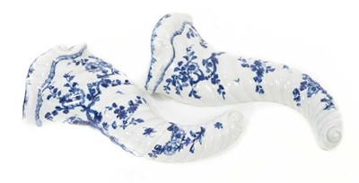 Lot 158 - A pair of Worcester blue and white cornucopia-form wall pockets, circa 1757-60, painted with the Cornucopia Prunus pattern, pseudo crossed-swords marks, 29cm long