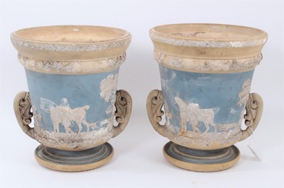 Lot 90 - Large pair of 19th century jasperware urns, probably Wedgwood, decorated with figural scenes on a two-tone light blue and buff ground, 29.5cm high