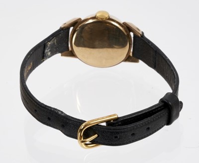 Lot 568 - 1950s ladies Longines gold wristwatch on black leather strap