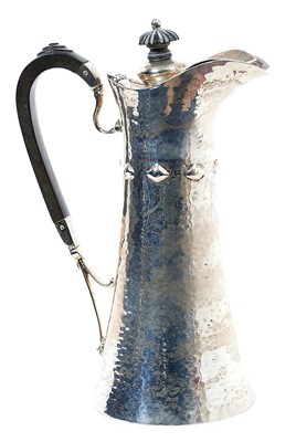 Lot 254 - Edwardian silver water jug of tapering form, with raised decoration and spot hammered finish