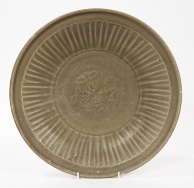 Lot 102 - Chinese celadon dish, Yuan dynasty, from the Java shipwreck, with ribbed moulding and central floral medallion, 31.5cm diameter