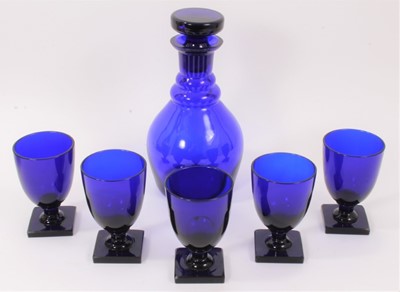 Lot 174 - A ‘Bristol’ blue tinted glass decanter and stopper and five rummers, each on square base