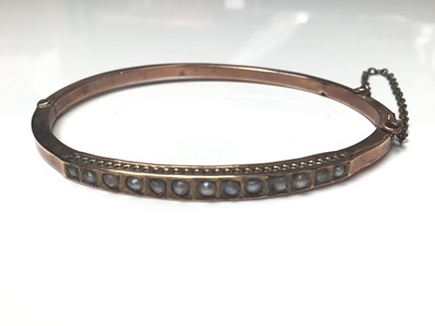 Lot 17 - Victorian yellow metal and seed pearl bangle