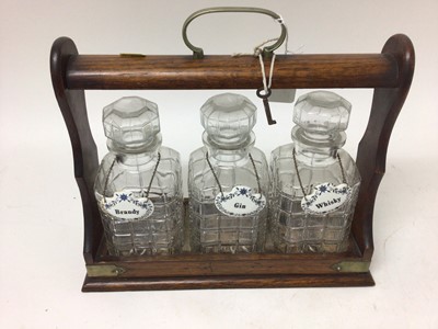 Lot 2422 - Edwardian three bottle oak tantalus