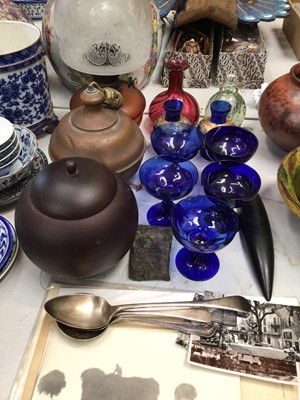 Lot 332 - Glass oil lamp, copper lamp, five blue glasses, cranberry glass vase, three silver plated serving spoons, old photographs and other ephemera