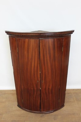 Lot 1403 - George III mahogany bow fronted, double door corner cupboard