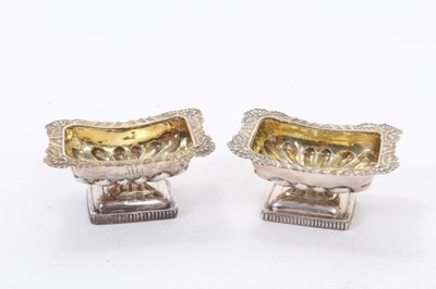 Lot 386 - Pair of 19th century Russian silver gilt salt cellars of rectangular form with fluted decoration and foliate borders raised on pedestal feet, marks to interior- 84 and dated 1828, all at 2.5ozs, 8c...