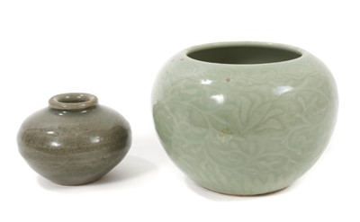 Lot 162 - Chinese celadon glazed vase, 19th century, with incised foliate patterns and Ruyi border, six-character Yongzheng mark to base, 9.5cm high, together with a Song period celadon glazed jarlet (2)