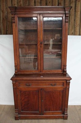 Lot 1300 - Late Victorian mahogany two height bookcase with shelved interior enclosed by two glazed doors with single drawer and cupboards below, 108cm wide x 46cm deep x 208cm high