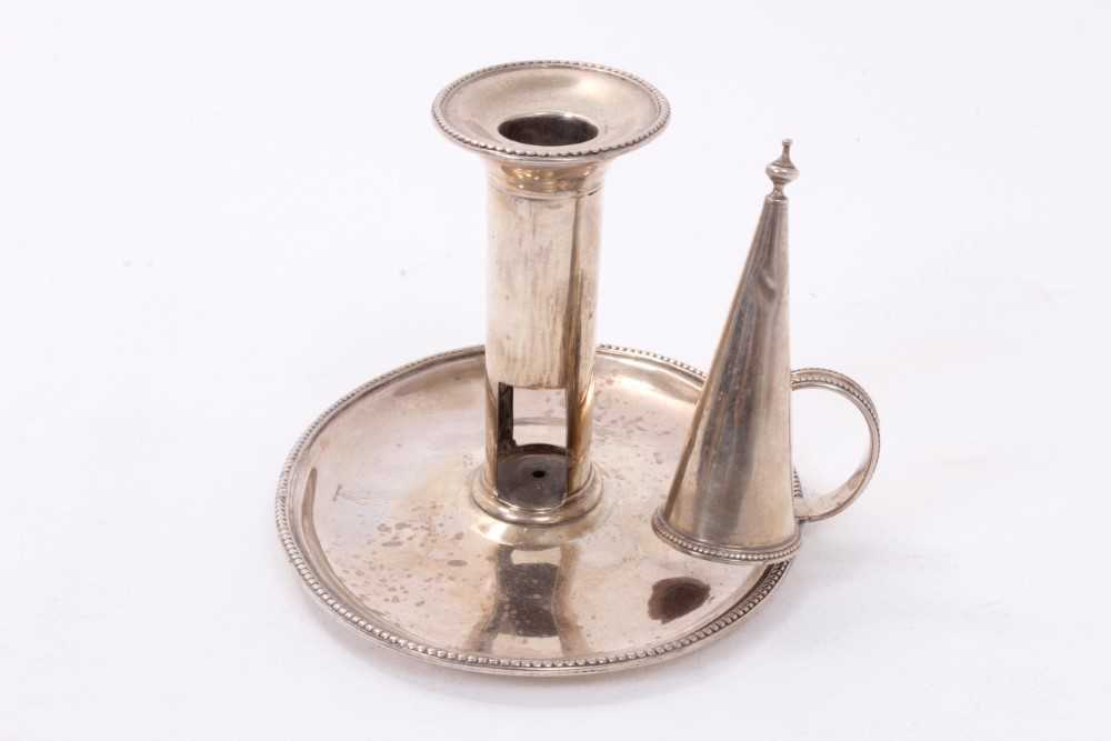 Lot 414 - George III silver chamberstick of oval form with beaded borders, removable snuffer and sconce, and engraved armorials, (London 1786), maker Thomas Chawner, all at 8ozs, 16cm in diameter.