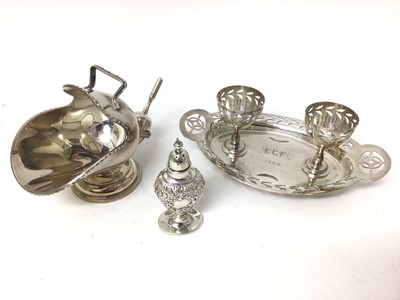 Lot 237 - Sterling silver caster, relief-decorated in the rococo style, together with a plated egg cruet and a plated sugar cattle and scoop
