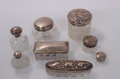 Lot 139 - Group of seven Victorian and later silver topped cut glass vanity jars together with a cut glass scent bottle with silver plated top (various dates and makers) (8).