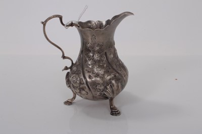 Lot 159 - George III silver milk / cream jug of baluster form, with later chased decoration, raised on three hoof feet, (London 1762), 3ozs, 10.5cm in overall height.