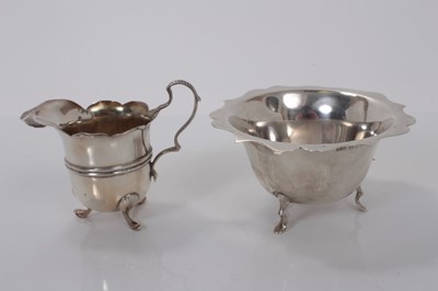 Lot 170 - Edwardian silver sugar bowl, raised on three hoof feet, (Birmingham 1902), together with a similar Edwardian silver cream jug (Sheffield 1901), all at 5ozs, (2)
