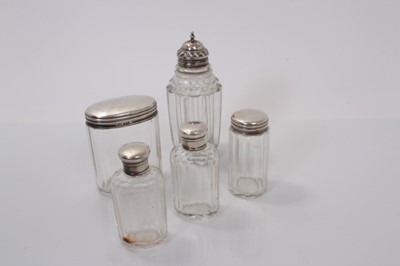 Lot 541 - George III silver topped cut glass caster, (Sheffield 1820), together with silver topped cut glass vanity jars (various dates and makers) (5)