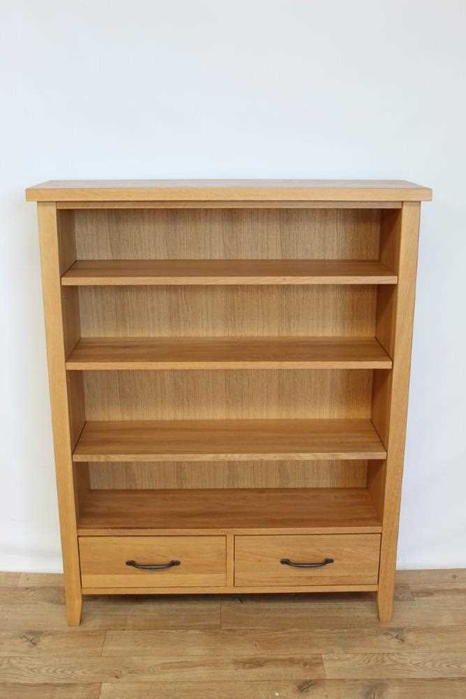 Lot 17 - Contemporary light oak open bookcase with adjustable shelves and two drawers below, 95cm wide, 28.5cm deep, 120cm high