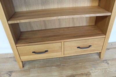 Lot 17 - Contemporary light oak open bookcase with adjustable shelves and two drawers below, 95cm wide, 28.5cm deep, 120cm high