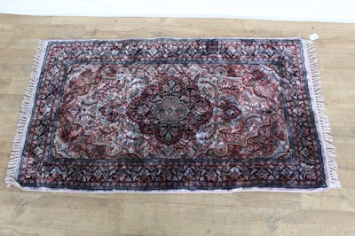 Lot 1355 - Eastern rug with floral decoration, 128cm x 76cm