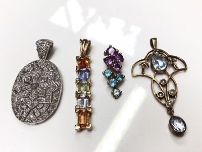 Lot 72 - 9ct white gold diamond set pierced oval panel pendant, Edwardian style 9ct gold open work pendant and two 9ct gold multi-coloured gem set pendants (4)