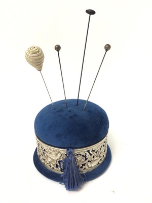 Lot 193 - Sterling silver mounted pin cushion, the pierced decoration with birds, flowers and scrollwork patterns, hallmarked for William Comyns, London 1895, together with four hat pins