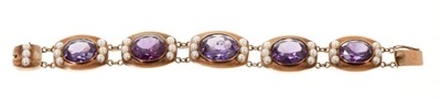 Lot 451 - Gold and faux Alexanderite and cultured pearl bracelet with five graduated oval mixed-cut faux Alexanderites flanked by cultured pearls in yellow gold setting.