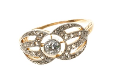 Lot 452 - Art Deco diamond ring with a central old cut diamond in openwork plaque with rose cut diamonds in platinum millegrain setting on gold shank with finely engraved shoulders.