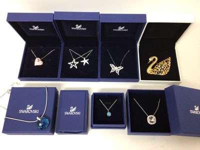 Lot 112 - Swarovski crystal pendant necklaces and swan brooch, all boxed