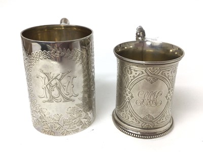 Lot 160 - Victorian silver mug with engraved floral decoration ( London 1862) 9cm high and another similar (Sheffield 1888) 9.5 cm high (2)