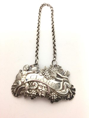 Lot 182 - George III silver claret label with putti and grapevine decoration (Birmingham 1813) 6.5 cm