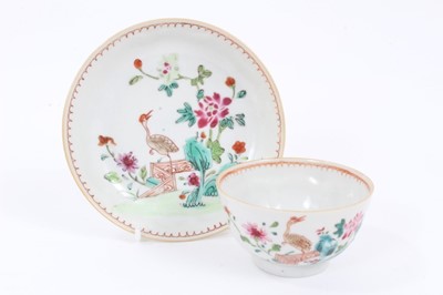 Lot 41 - Chinese famille rose export porcelain tea bowl and saucer, painted with an exotic bird in a fenced garden