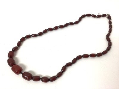 Lot 240 - Cherry red simulated amber necklace