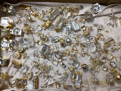 Lot 1295 - Large quantity of Swarovski crystal and gold coloured items including buildings, Viking ships, Lighthouse, pair of binoculars, Rolls Royce, train, jukebox, tennis racket, plane, World globe etc