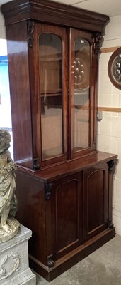 Lot 1303 - Victorian mahogany bookcase with two glazed doors enclosing 
shelves and two panelled doors below on platform base.
