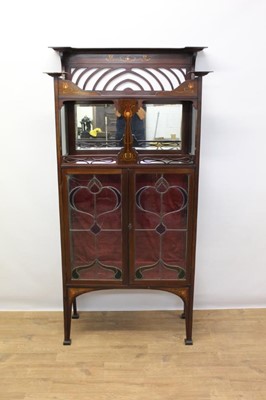 Lot 1304 - Good quality Edwardian Art Nouveau inlaid mahogany china 
display cabinet with two display tiers and two leaded and 
stained glass doors below tapered legs and block feet.