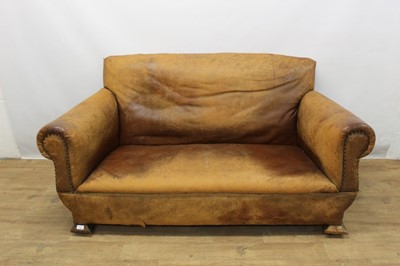 Lot 1306 - Edwardian Arts and Crafts leather covered two seater sofa 
on splayed block feet.
