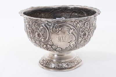 Lot 372 - Edwardian silver rose bowl of circular form with embossed floral and scroll decoration and engraved initials and inscription, (London 1904), maker Wakely & Wheeler, all at 11.5ozs, 18cm in diameter.
