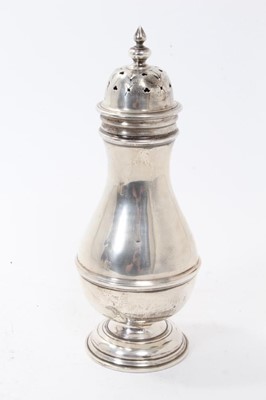 Lot 373 - George V silver sugar castor of baluster form with pieced slip in cover, raised on circular foot, (London 1916), all at 8ozs, 23cm in overall height.
