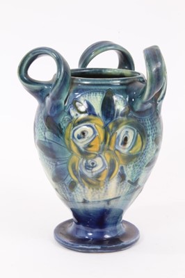 Lot 90 - Barum Barnstaple Art Nouveau three handled pottery vase with 
floral decoration.