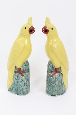 Lot 166 - Pair of Chinese porcelain yellow cockatoo perched on leafy mounted bases