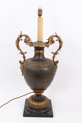 Lot 1483 - Early 20th century parcel gilt and brass two handled vase table 
lamp.