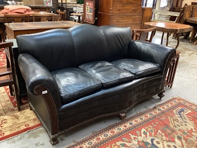 Lot 1312 - Edwardian black leather upholstered sofa and matching armchair 
with mahogany frame on claw and ball feet.