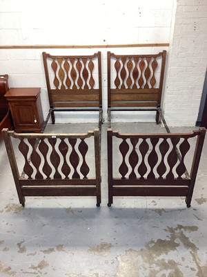 Lot 1326 - Pair of Edwardian Arts & Crafts single bedsteads, in the manner 
of Liberty’s